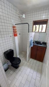 a bathroom with a black toilet and a sink at Get Up Hostel in Natal