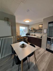 ÓlafsfjörðurKlara Guesthouse的一间带桌子的客厅和一间厨房