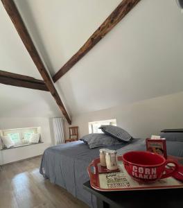 a bedroom with a bed and a table with a coffee cup at Il lupo e il filosofo b&b in Pontinvrea