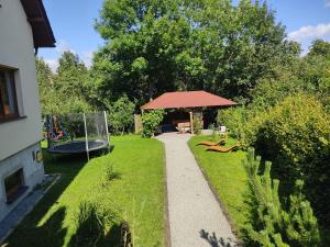 a garden with a gazebo and a playground at Wiśniowy Sad in Kudowa-Zdrój