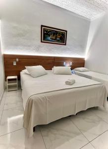 a bedroom with a large bed in a room at Pousada e Chalés Arco-Íris in Lima Duarte +101 photos