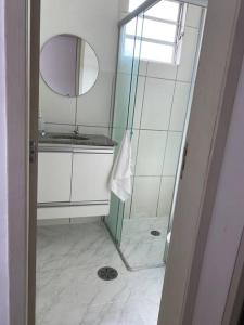 a bathroom with a shower and a mirror at Apartamento Firenze in Franca +9 photos
