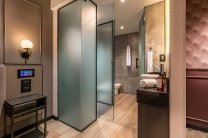 a bathroom with a glass shower and a toilet at Up Laprida in Buenos Aires