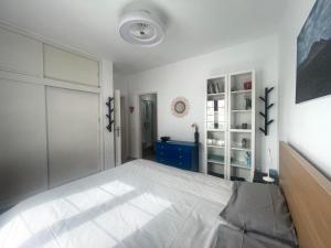 a bedroom with a white bed and a blue dresser at Casita MATILDA Puerto del Carmen in Puerto del Carmen +12 photos