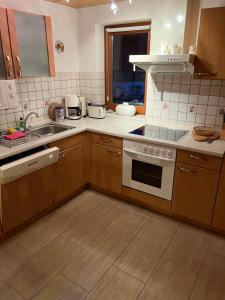 a kitchen with a sink and a stove top oven at Ferienwohnung Zschopautal in Mittweida +3 photos