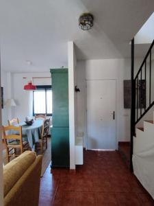 a living room with a table and a green cabinet at La Casita de Wilson in Los Marines