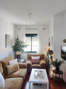 ein Wohnzimmer mit zwei Sofas und einem Couchtisch in der Unterkunft La Casita de Wilson in Los Marines