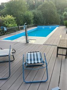 a deck with two chairs and a swimming pool at Ferienwohnung Zschopautal in Mittweida