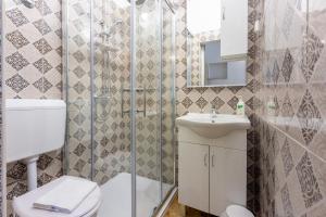 a bathroom with a toilet and a sink at Tustonjic in Novi Vinodolski +65 photos