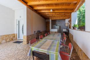 a long table and chairs in a room with a table and chairsktop at Tustonjic in Novi Vinodolski
