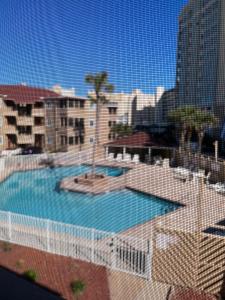a view of a swimming pool in a city at Cherry Grove condo just steps from the ocean in Myrtle Beach