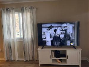 a flat screen tv sitting on a tv stand at Cherry Grove condo just steps from the ocean in Myrtle Beach