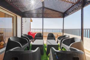 a room with chairs and a table with green grass at Nabeel Homes - Penthouse Duplex with Rooftop in Alexandria