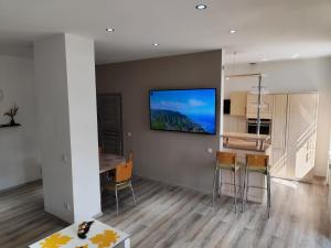 eine Küche und ein Esszimmer mit einem Fernseher an der Wand in der Unterkunft Conco Zeitz in Zeitz