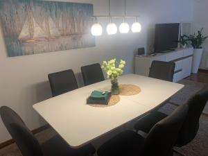 a dining room table with a vase of flowers on it at Remi in Slavonski Brod +12 photos