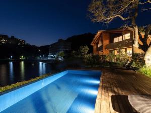 a swimming pool next to a river at night at Hamabe Oura - Vacation STAY 46735v in Shimoda