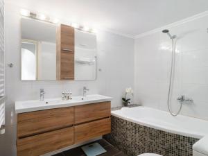 a bathroom with a sink and a tub and a toilet at Bali Bay Luxury Apartment in Balíon +25 photos