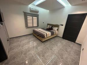a bedroom with a bed and a window at BLU Apartments Sébénicoro in Bamako