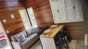 a living room with a couch and a table at Chale Vale Carahá Lavanda in Gramado