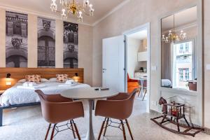 a bedroom with a bed and a table and chairs at La casa di Irene - Suites con vista in Ragusa