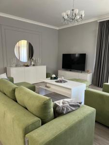a living room with a couch and a tv at VILLAge GOGHT in Goghtʼ