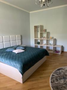 a bedroom with a large bed with a blue comforter at VILLAge GOGHT in Goghtʼ +34 photos