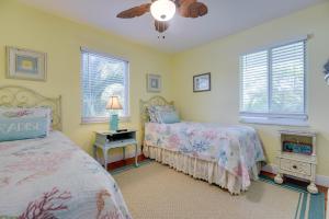 a bedroom with two beds and a ceiling fan at Cedar Cottage in Big Pine Key