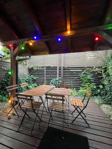 a picnic table and chairs on a wooden deck at Casa del Mar free Parking Only Adults for Young U45yrs in Międzyzdroje