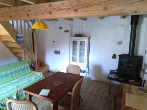 a living room with a table and a couch at maison dans village rural in Saint-Louis-et-Parahou