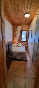 a bedroom with a bed in a wooden room at Tahko Hovimäenraitti 5A in Tahkovuori