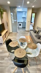 a living room with a glass table and chairs at Lapaserina-A in Arenas de Cabrales