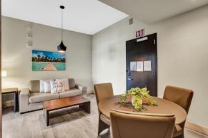 a living room with a table and a couch at Luxury Beach Front Suite with Rooftop Pool in Hollywood