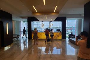 a group of people standing in a lobby at Luxury Beach Front Suite with Rooftop Pool in Hollywood +44 photos