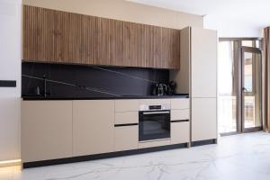 a kitchen with white cabinets and a stove at Apartment PREMIUM CALPE in Ifach