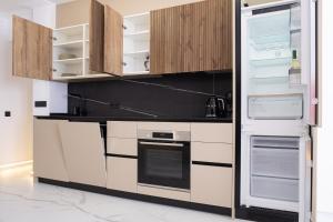 a kitchen with white cabinets and an open refrigerator at Apartment PREMIUM CALPE in Ifach +40 photos