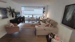 a living room with a couch and chairs and a table at El balconcito al mar in Nerja