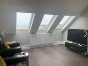 a living room with skylights and a flat screen tv at Docharna Lodge in Kilkee
