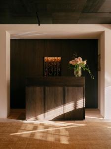a vase of flowers on a wooden cabinet in a room at Hotel Schwarzwand in Lech am Arlberg +52 photos