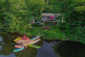 an aerial view of a house with boats in the water at Chalet du Domaine Spa privé et lac in Saint Adolphe D'Howard