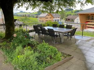 a table and chairs sitting on a patio at 22 - Gästehaus Erika - Hundwil - Appenzellerland in Hundwil
