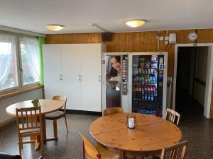 a dining room with a table and a refrigerator at 22 - Gästehaus Erika - Hundwil - Appenzellerland in Hundwil