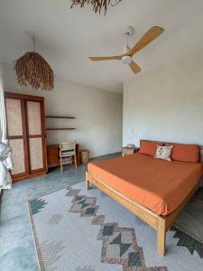 a bedroom with a bed and a ceiling fan at Casa Deriva - Modern 3 Bedroom AC with Pool in Playa Maderas