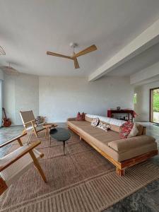 a living room with a couch and a table at Casa Deriva - Modern 3 Bedroom AC with Pool in Playa Maderas +13 photos