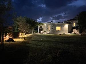 a house lit up at night in a yard at vaya_living in Ktistádes