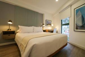 a bedroom with a large white bed and a window at 1BR near Central Restaurant in Barranco by Wynwood House in Lima