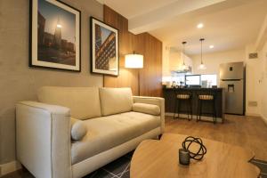 a living room with a couch and a table at 1BR near Central Restaurant in Barranco by Wynwood House in Lima