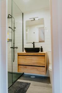 a bathroom with a sink and a mirror at O Vicedo Beach Resort WEST in O Vicedo
