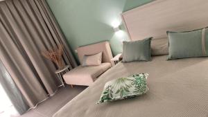 a bedroom with a large bed with a pillow on it at Residence Torre Delle Viole in Marina di Camerota +63 photos