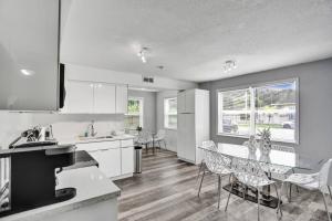 a kitchen and dining room with a table and chairs at Luxury Miami Retreat in North Miami