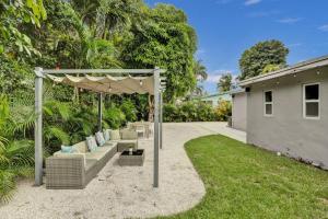 a backyard with a pergola and a couch at Luxury Miami Retreat in North Miami
